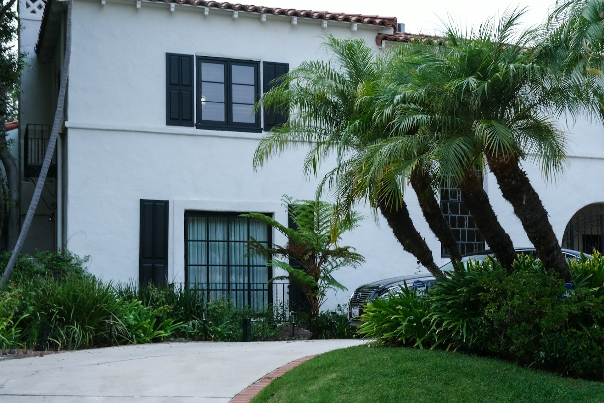 Welcoming Mediterranean-style home exterior with palm trees